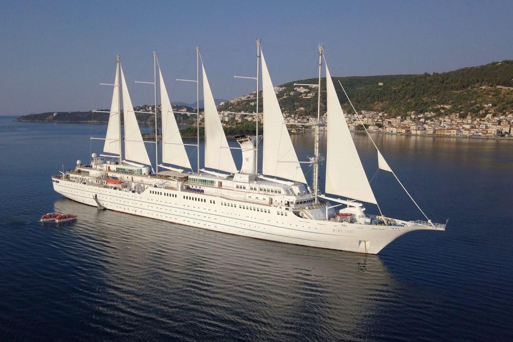 Wind Star sailing cruise ship under full sails in a quiet harbor