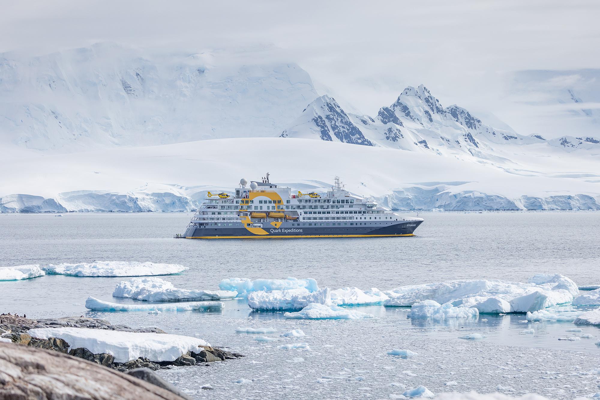 Quark Expeditions ship Ultramarine with its helicopters among sea ice in Antarctica