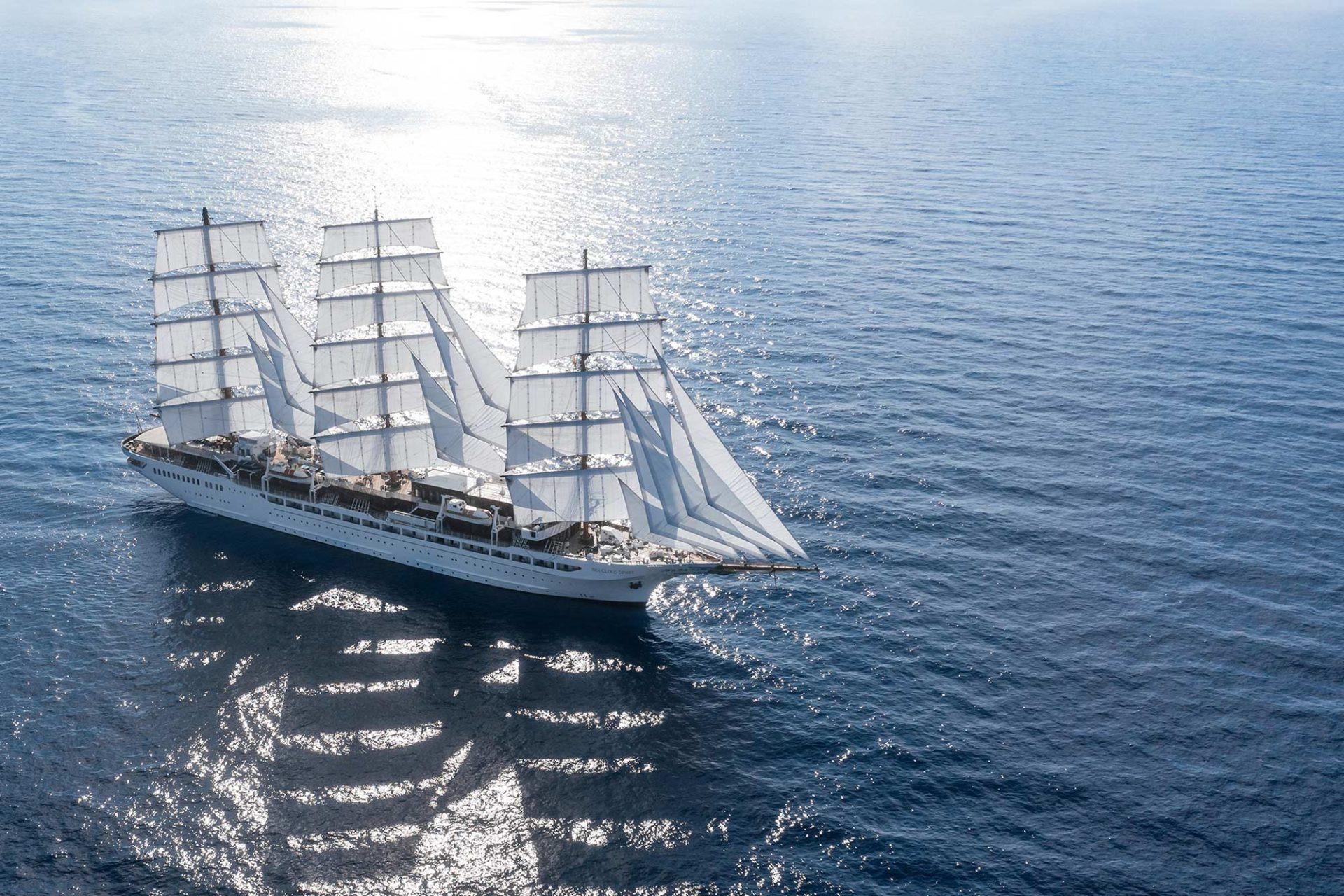 Sea Cloud Spirit tall ship under full white sails on open sunlit sea