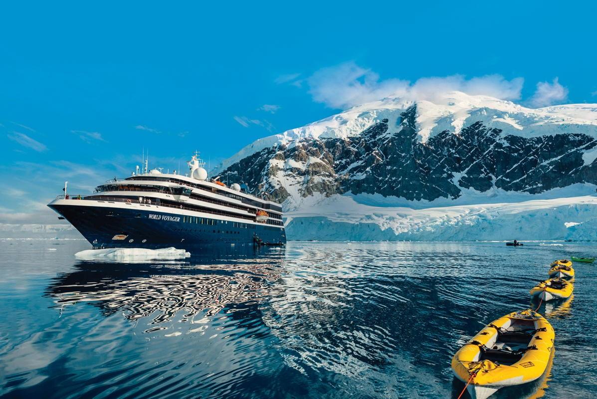 Atlas Ocean Voyages ship World Voyager with kayaks among Antarctic glaciers