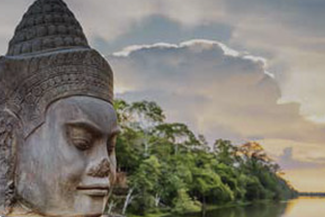 Carved stone face at the gates of Angkor Thom beside the river, Cambodia