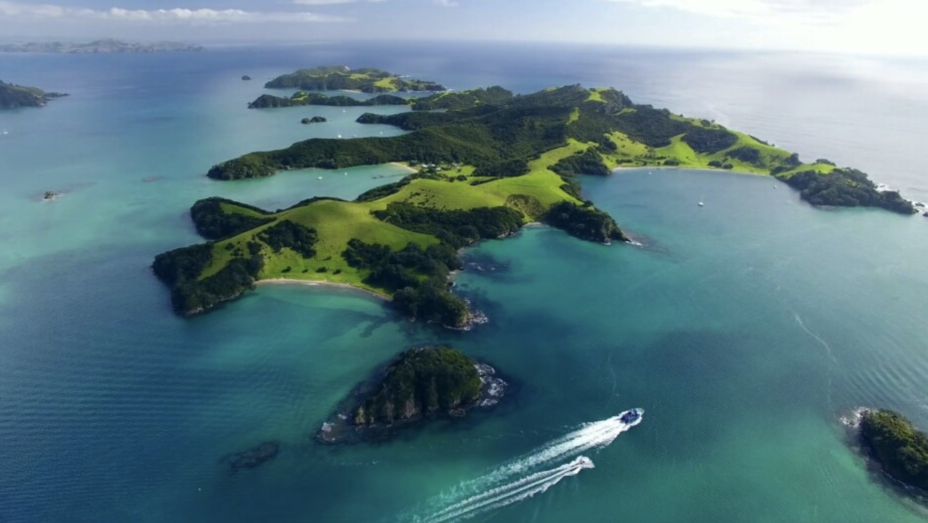 Green islands and turquoise water in the Bay of Islands, Northland, New Zealand