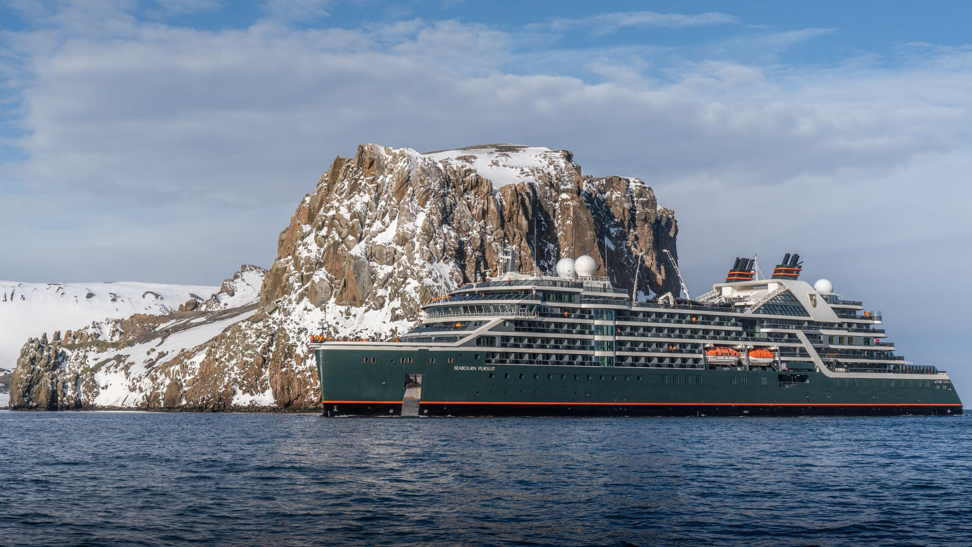 Seabourn expedition ship Seabourn Pursuit beside a snowy cliff in Antarctica