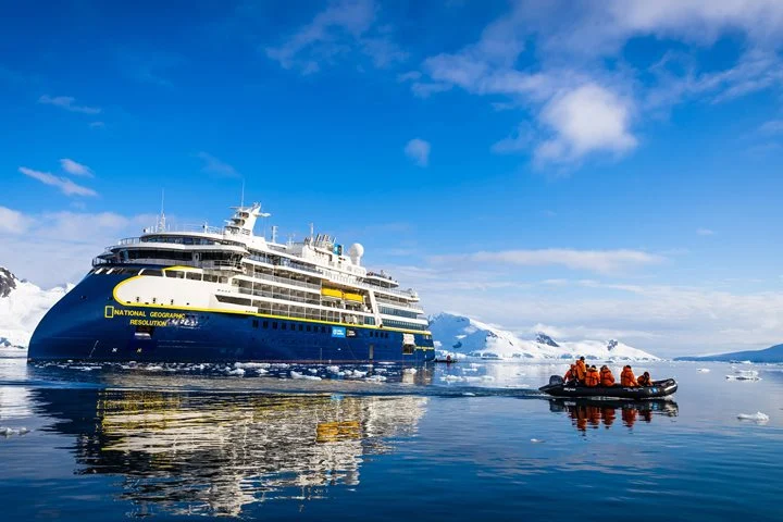 Lindblad Expeditions-National Geographic ship National Geographic Resolution and a Zodiac of guests in Antarctica