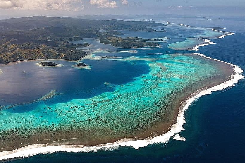 Aerial view of the Great Astrolabe Reef off Kadavu, Fiji, with turquoise coral and breaking surf