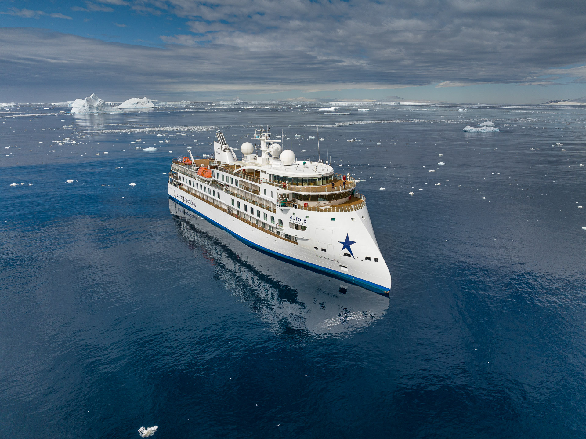 Aurora Expeditions ship Greg Mortimer among sea ice and icebergs in Antarctica